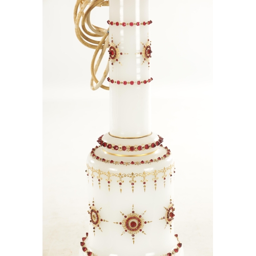 29 - A 19TH CENTURY OPAQUE GLASS TABLE LAMP with ruby glass jewels and gilt decoration. (lamp base 57cm h... 