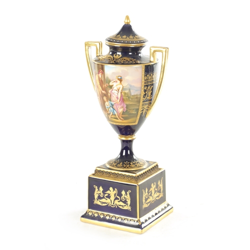 32 - A 19TH CENTURY VIENNA PORCELAIN TWO HANDLED LIDDED URN SHAPED VASE ON PEDESTAL the richly gilded roy... 