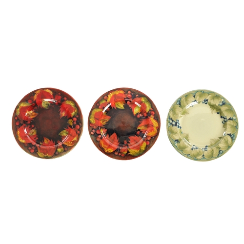 38 - A PAIR OF 1930/40'S W MOORCROFT PLATES decorated in the leaf and berry pattern under a flambe glaze ... 