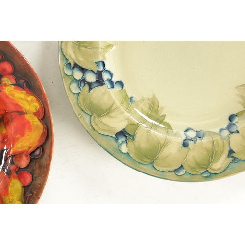 38 - A PAIR OF 1930/40'S W MOORCROFT PLATES decorated in the leaf and berry pattern under a flambe glaze ... 