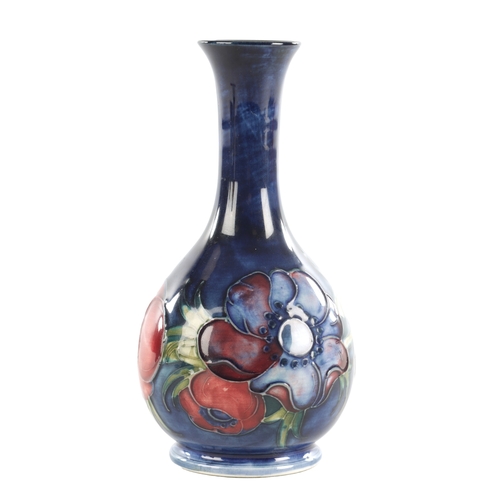 44 - A WALTER MOORCROFT ANEMONE PATTERN BULBOUS VASE with a slender neck and label to under side. (15cm h... 