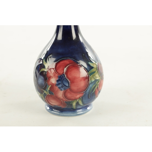 44 - A WALTER MOORCROFT ANEMONE PATTERN BULBOUS VASE with a slender neck and label to under side. (15cm h... 