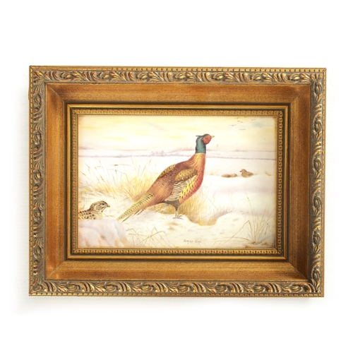 45 - A ROYAL WORCESTER HAND PAINTED CERAMIC PLAQUE DECORATED WITH PHEASANT IN THE SNOW SIGNED BRYAN COX