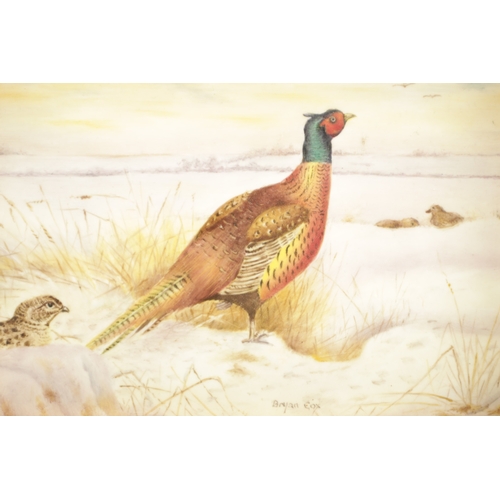 45 - A ROYAL WORCESTER HAND PAINTED CERAMIC PLAQUE DECORATED WITH PHEASANT IN THE SNOW SIGNED BRYAN COX