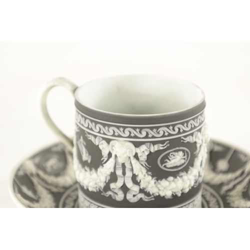 71 - A 19TH CENTURY WEDGWOOD BLACK BASALT JASPERWARE CABINET CUP AND SAUCER with Adam style swag work dec... 