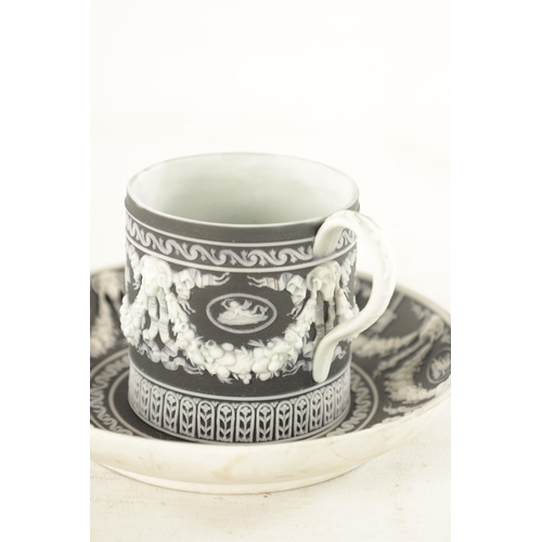 71 - A 19TH CENTURY WEDGWOOD BLACK BASALT JASPERWARE CABINET CUP AND SAUCER with Adam style swag work dec... 