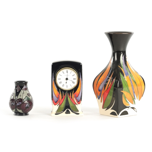 73 - A COLLECTION OF THREE MOORCROFT ITEMS, comprising of a clock with electric movement, a matching vase... 