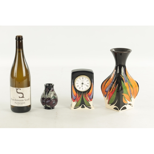 73 - A COLLECTION OF THREE MOORCROFT ITEMS, comprising of a clock with electric movement, a matching vase... 