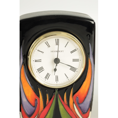 73 - A COLLECTION OF THREE MOORCROFT ITEMS, comprising of a clock with electric movement, a matching vase... 