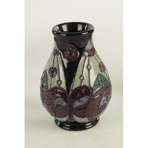 73 - A COLLECTION OF THREE MOORCROFT ITEMS, comprising of a clock with electric movement, a matching vase... 