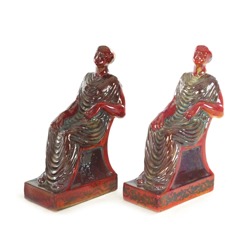 81 - A RARE PAIR OF PILKINGTON ROYAL LANCASTRIAN LUSTRE FLAMBE GLAZE BOOK ENDS, modelled as seated maiden... 