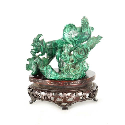 91 - A LATE 19TH CENTURY CHINESE CARVED MALACHITE SCULPTURE of a bird in foliate setting; raised on a wir... 