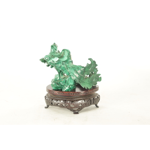 91 - A LATE 19TH CENTURY CHINESE CARVED MALACHITE SCULPTURE of a bird in foliate setting; raised on a wir... 