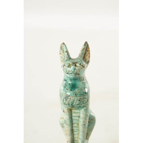 209 - AN EARLY EGYPTIANESQUE STONEWARE SCULPTURE OF A CAT seated in an alert pose on a plinth base glazed ... 