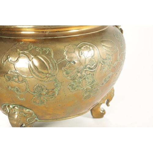 215 - A 19TH CENTURY CHINESE BRONZE JARDINIERE of bulbous squat form decorated with floral work; raised on... 