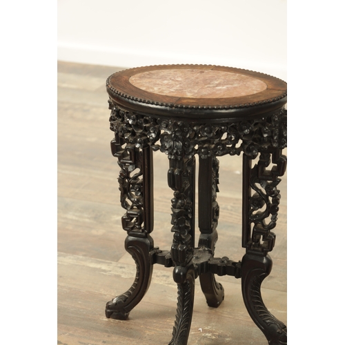 220 - A 19TH CENTURY CHINESE HARDWOOD OVAL SHAPED VASE STAND with inset marble top and cutout frieze and c... 