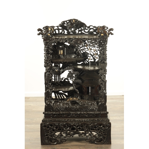 221 - A GOOD 19TH CENTURY CARVED CHINESE HARDWOOD DISPLAY CABINET finely decorated with pierced branchwork... 