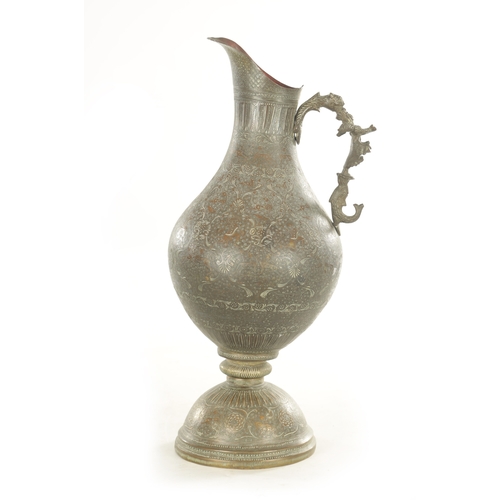 224 - A 19TH CENTURY INDIAN PROFUSELY ENGRAVED AND EMBOSSED GIANT EWER with ornate animal head and cast wi... 