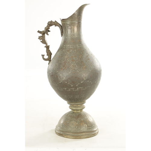 224 - A 19TH CENTURY INDIAN PROFUSELY ENGRAVED AND EMBOSSED GIANT EWER with ornate animal head and cast wi... 