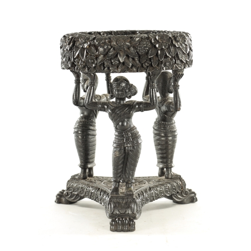 225 - A 19TH CENTURY CARVED EBONY ANGLO INDIAN JARDINIERE STAND with figural supports and leaf carved deco... 