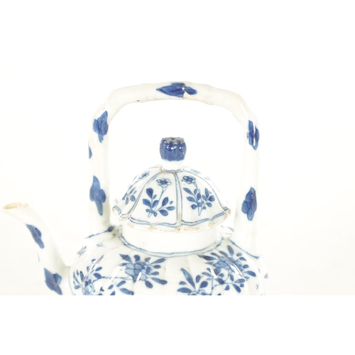 231 - AN EARLY CHINESE BLUE AND WHITE TEAPOT BEARING KANGXI MARK BENEATH the shaped and fluted body with t... 