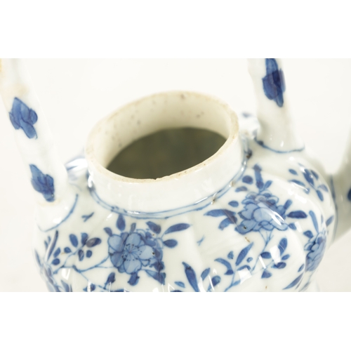 231 - AN EARLY CHINESE BLUE AND WHITE TEAPOT BEARING KANGXI MARK BENEATH the shaped and fluted body with t... 