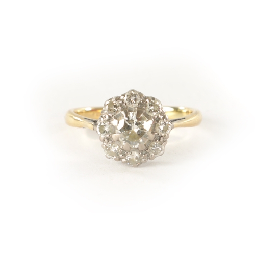 252 - AN 18CT GOLD AND DIAMOND DAISY RING, with an app. 0.5ct centre stone surrounded by eight smaller sto... 