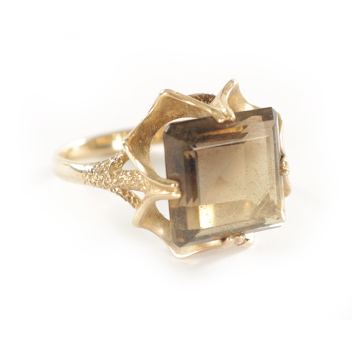 254 - A LARGE 9CT GOLD SMOKEY QUARTZ RING with stylish textured four-claw setting and large square cut qua... 