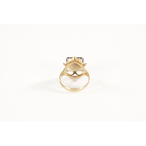 254 - A LARGE 9CT GOLD SMOKEY QUARTZ RING with stylish textured four-claw setting and large square cut qua... 