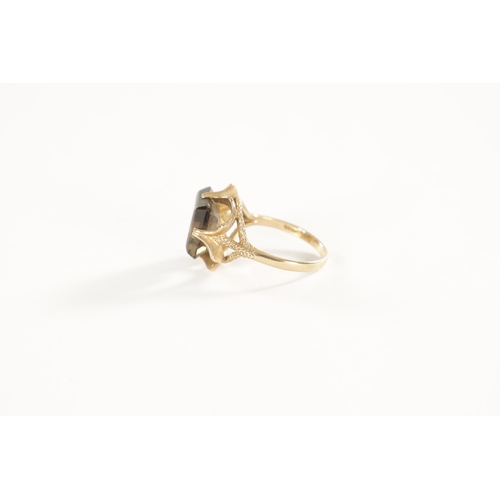 254 - A LARGE 9CT GOLD SMOKEY QUARTZ RING with stylish textured four-claw setting and large square cut qua... 