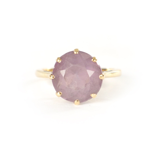 256 - AN 18CT GOLD AND AMETHYST RING with claw setting - stamped 18ct, size K, 3.8 grams approx.