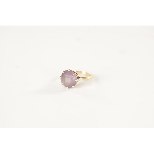 256 - AN 18CT GOLD AND AMETHYST RING with claw setting - stamped 18ct, size K, 3.8 grams approx.