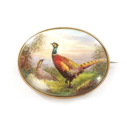 260 - A LATE 19TH CENTURY PAINTED PORCELAIN BROOCH, of oval convex form, finely painted with a cock and he... 