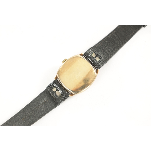 297 - A GENTLEMAN’S 1950’S 9CT GOLD CUSHION CASED ROLEX TUDOR WRISTWATCH, on black strap, the champagne en... 