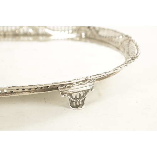 365 - A VICTORIAN SILVER OVAL TRAY the plain centre within a cast Adam-style pierced border set with mask ... 