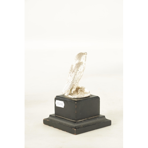 372 - AN ELIZABETH II CAST SILVER SCULPTURE OF AN OWL realistically modelled with a matt finish perched on... 