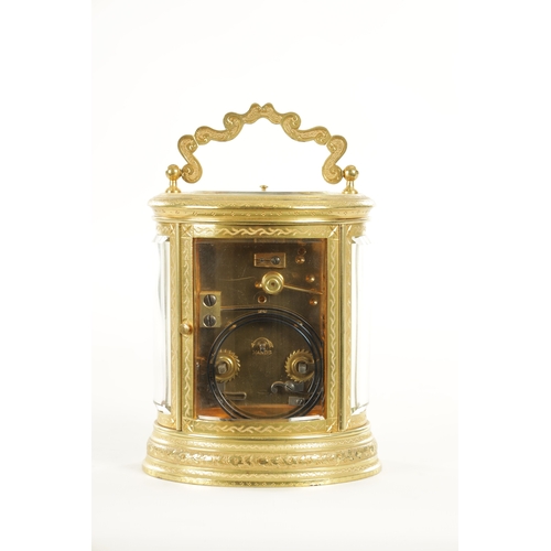 1028 - A LATE 19TH CENTURY FRENCH ENGRAVED OVAL CASED REPEATING CARRIAGE CLOCK the brass case with foliate ... 