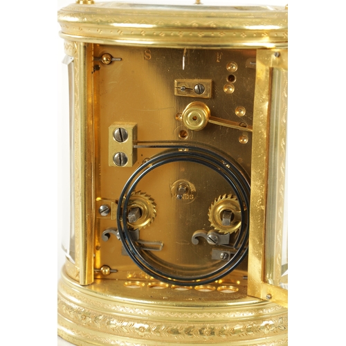 1028 - A LATE 19TH CENTURY FRENCH ENGRAVED OVAL CASED REPEATING CARRIAGE CLOCK the brass case with foliate ... 