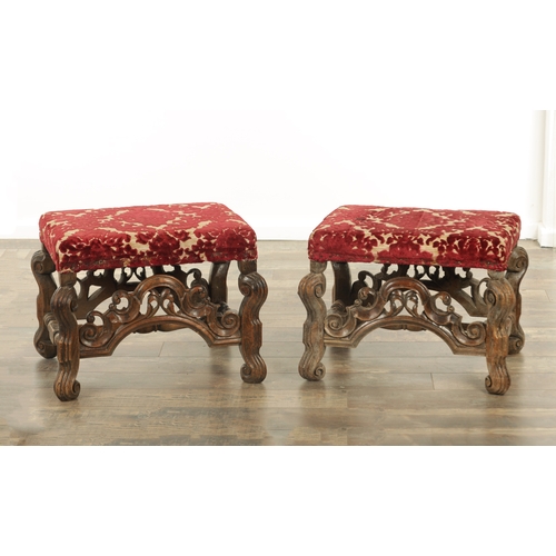 1388 - A PAIR OF 17TH CENTURY AND LATER WALNUT UPHOLSTERED STOOLS with arched leaf-carved stretchers and sc... 