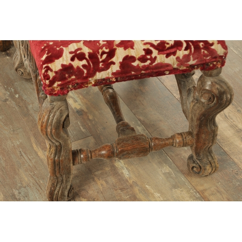 1388 - A PAIR OF 17TH CENTURY AND LATER WALNUT UPHOLSTERED STOOLS with arched leaf-carved stretchers and sc... 