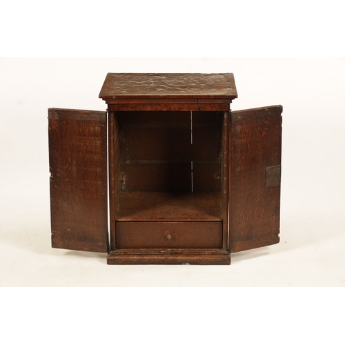 1392 - A WILLIAM AND MARY BURR WALNUT HANGING CUPBOARD the moulded cornice above a pair of hinged doors enc... 