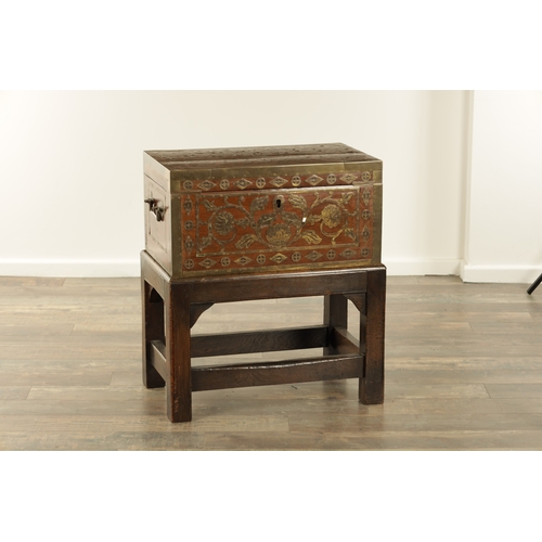 112 - AN 18TH CENTURY INDIAN BRASS BOUND AND SCROLL INLAID HARDWOOD FITTED DRESSING BOX ON STAND with fitt... 