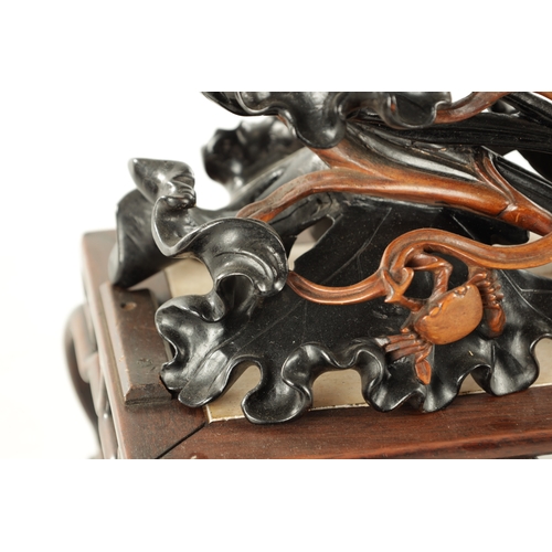 135 - AN IMPRESSIVE 19TH CENTURY CHINESE CARVED HARDWOOD AND BRONZE MOUNTED SCULPTURE with overhanging flo... 