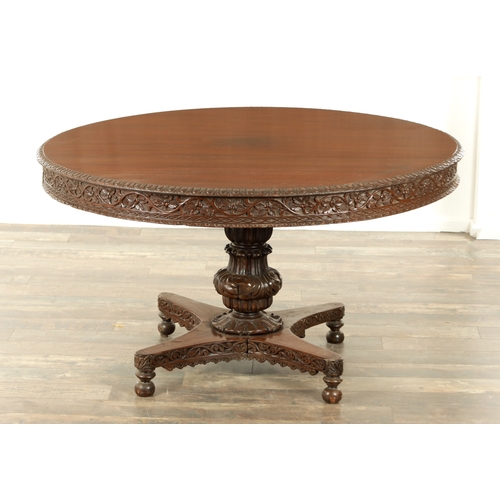 176 - A LARGE EARLY 19TH CENTURY INDIAN HARDWOOD CENTRE TABLE with carved floral frieze raised on a bulbou... 