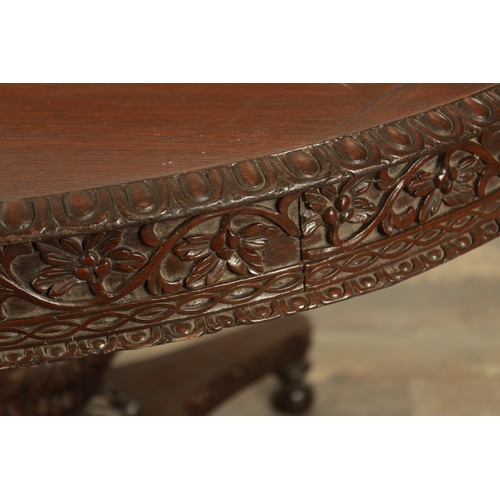 176 - A LARGE EARLY 19TH CENTURY INDIAN HARDWOOD CENTRE TABLE with carved floral frieze raised on a bulbou... 