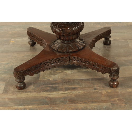 176 - A LARGE EARLY 19TH CENTURY INDIAN HARDWOOD CENTRE TABLE with carved floral frieze raised on a bulbou... 