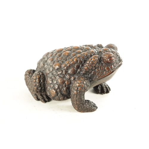 194 - A JAPANESE MEIJI PERIOD CARVED WOOD OKIMONO OF A TOAD realistically modelled with signature beneath.... 