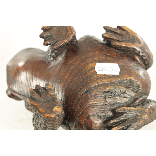 194 - A JAPANESE MEIJI PERIOD CARVED WOOD OKIMONO OF A TOAD realistically modelled with signature beneath.... 