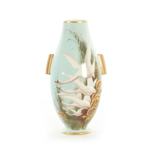 39 - AN EARLY 20TH CENTURY ROYAL WORCESTER CABINET VASE BY C. BALDWYN decorated with swans in flight on a... 