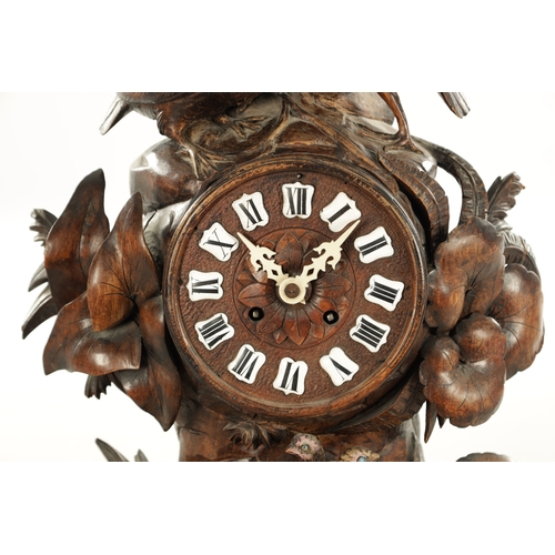 1010 - A 19TH CENTURY BLACK FOREST CARVED LINDEN WOOD MANTEL CLOCK with a family of grouse amongst foliage ... 